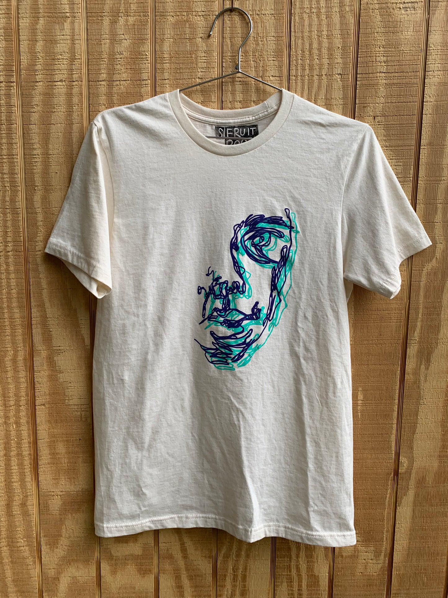 Off-white t shirt with purple and teal overlapping blind contour drawings of a face 